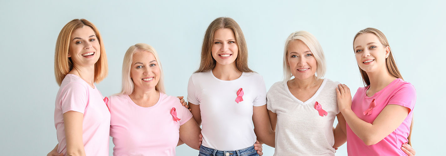 Beautiful women of different ages with pink ribbons for Breast Cancer Awareness.
