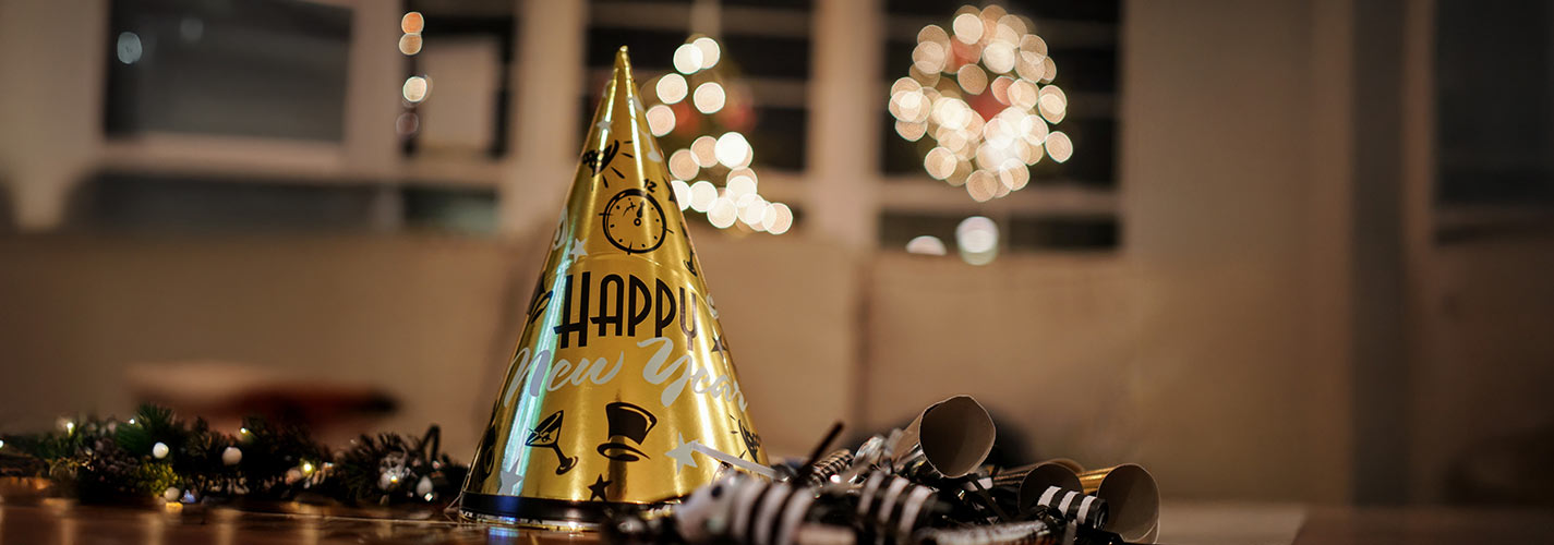 New Years eve party hat on a table with streamers